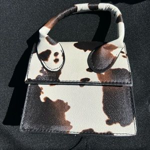 Beige and Brown Cow Mini Bag. Come with a chain on the inside.